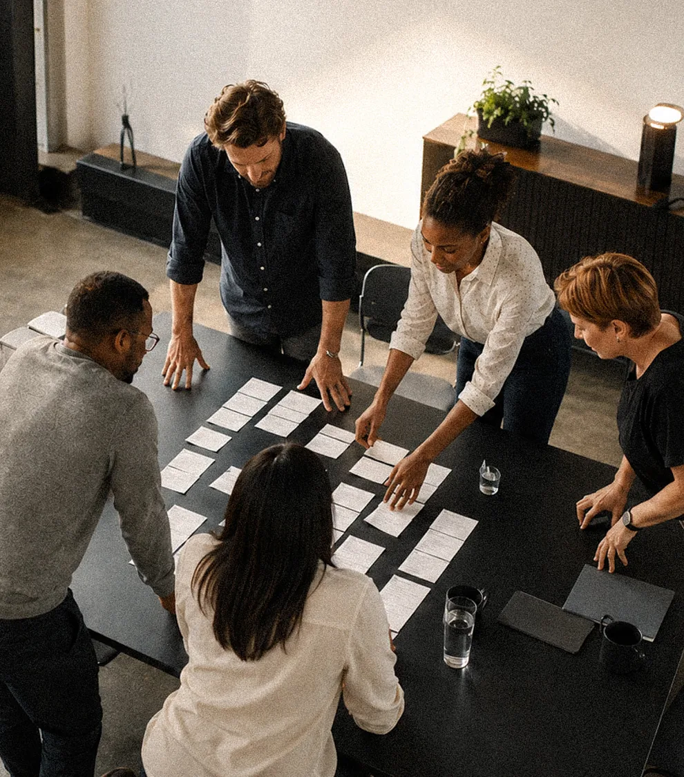 A team working through printed findings on a table